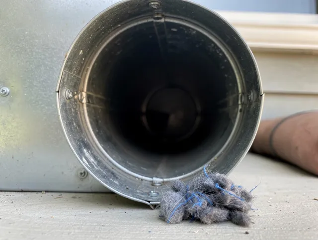Southington Dryer Vent Cleaning technician using specialized equipment to clear severe dryer vent blockage in Southington